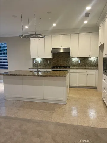 a bathroom with a granite countertop sink a mirror and shower