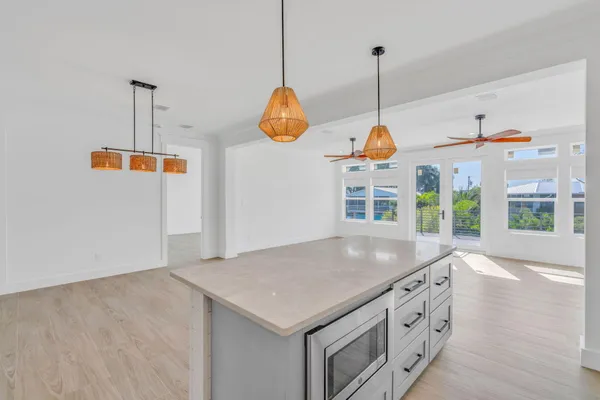 a kitchen that has a kitchen island hardwood floor and a sink