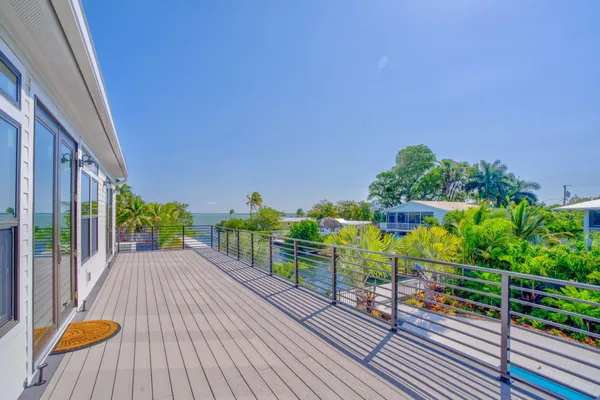 a view of a balcony with wooden floor