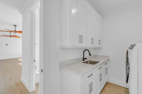 a view of a room with wooden floor and ceiling fan