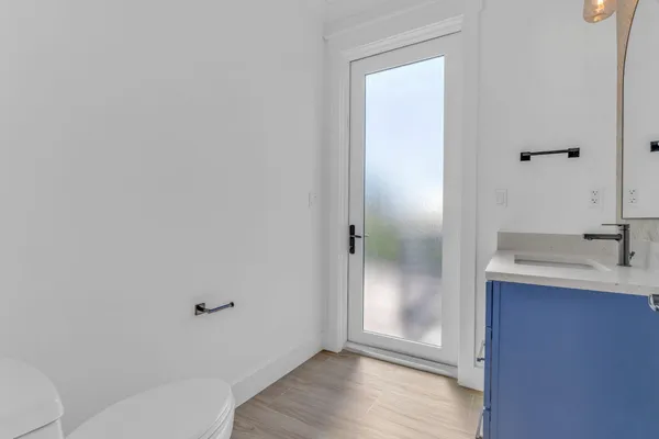 a view of a flower in a garden with wooden fence