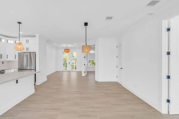 a view of a house with backyard and a tree
