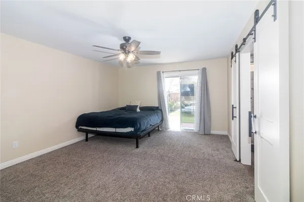 a living room with a couch and a ceiling fan