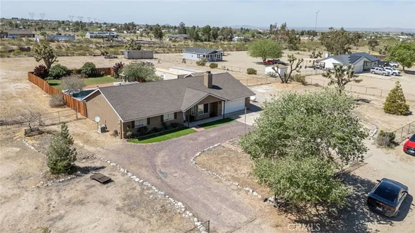 an aerial view of a house with a yard lake and city view