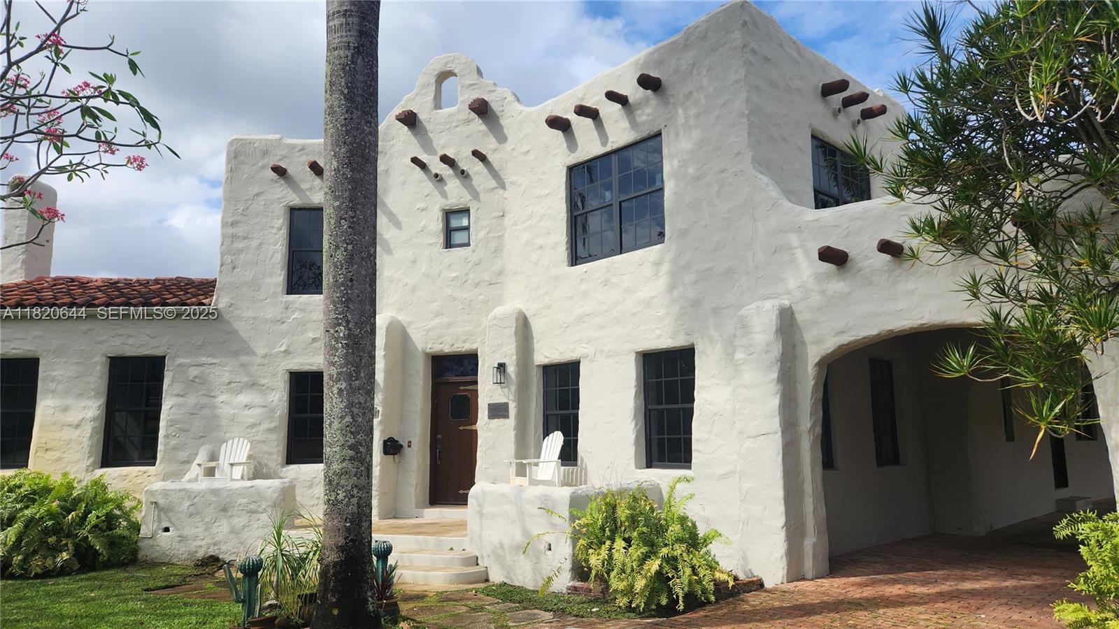 85 Deer Run Miami Springs, FL 33166 - Photo 5 of 21 a front view of a house with a garden