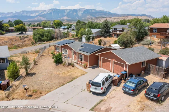 an aerial view of a houses with a city view
