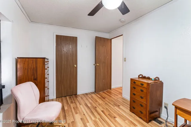 a bedroom with furniture and wooden floor