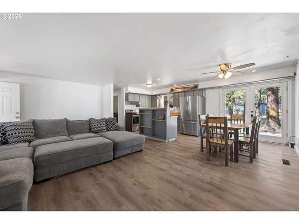 a living room with furniture and kitchen view
