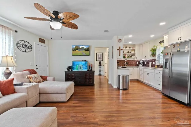 a kitchen with stainless steel appliances white cabinets and stove