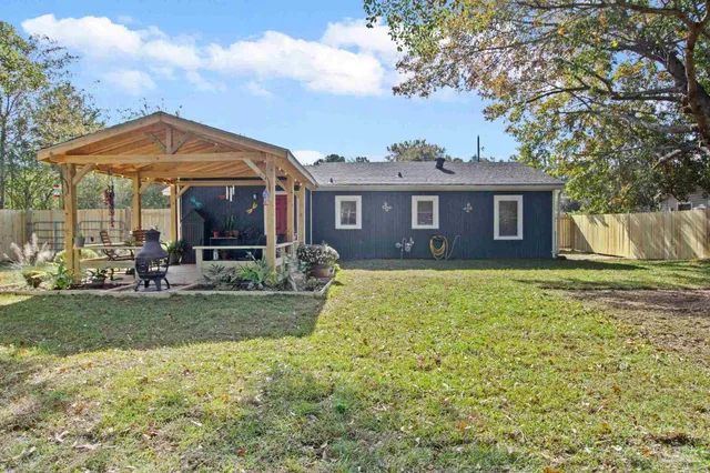 a view of a chairs and table in the patio