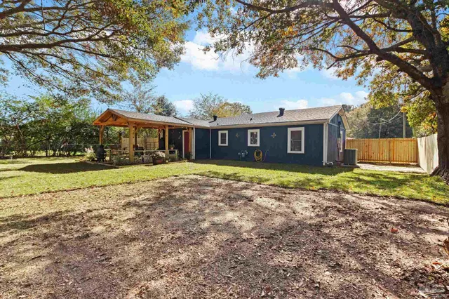 a view of a patio with table and chairs potted plants