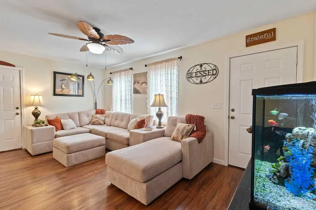 a living room with furniture and wooden floor