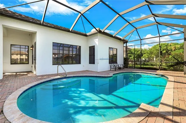 a swimming pool with outdoor seating