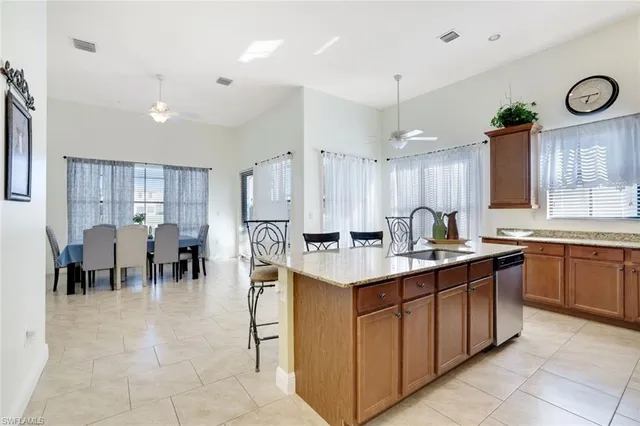 a large kitchen with a large counter top appliances and cabinets