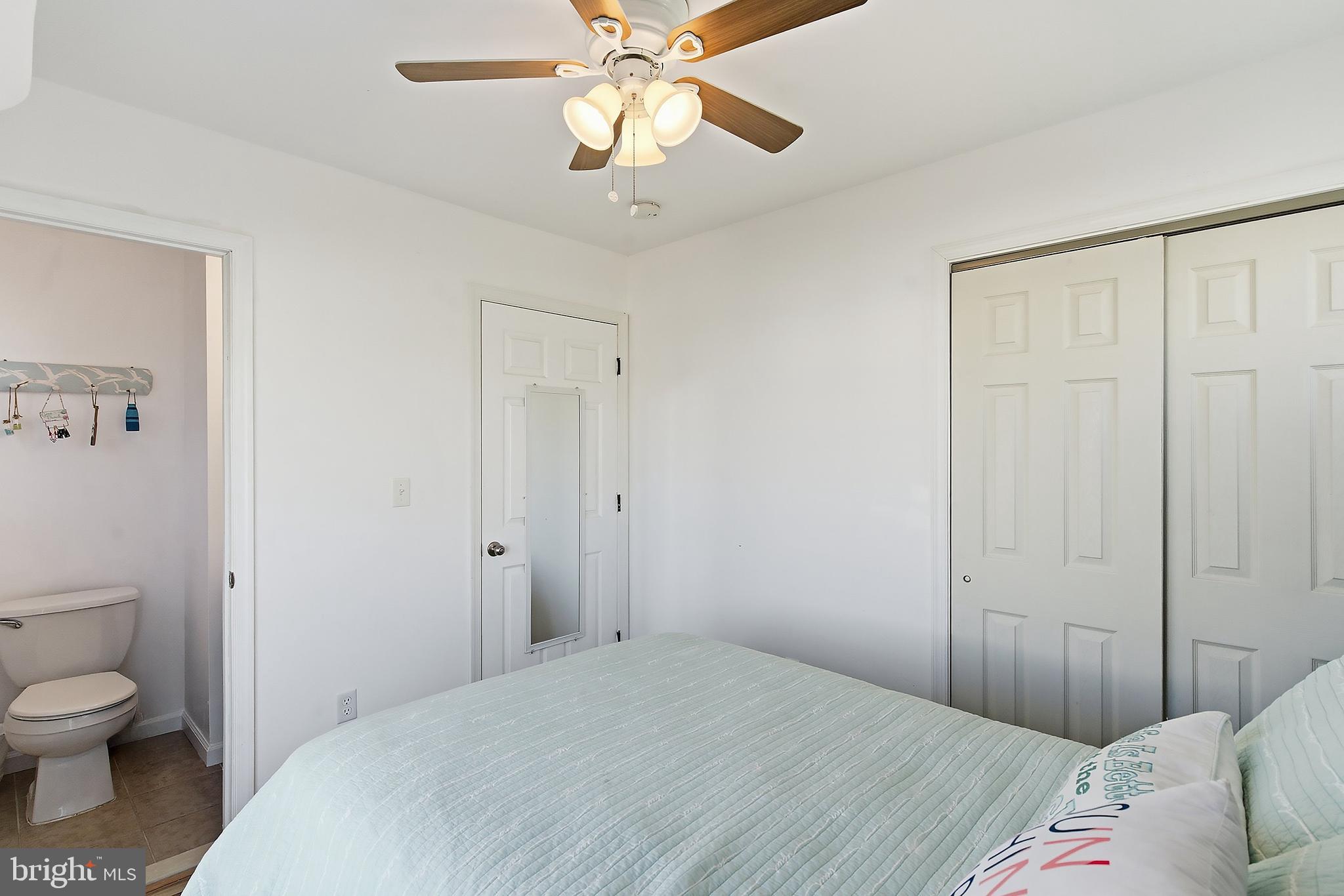102 West Pompano Way Lavallette, NJ 08735 - Photo 12 of 28 a bedroom with a bed and a chandelier