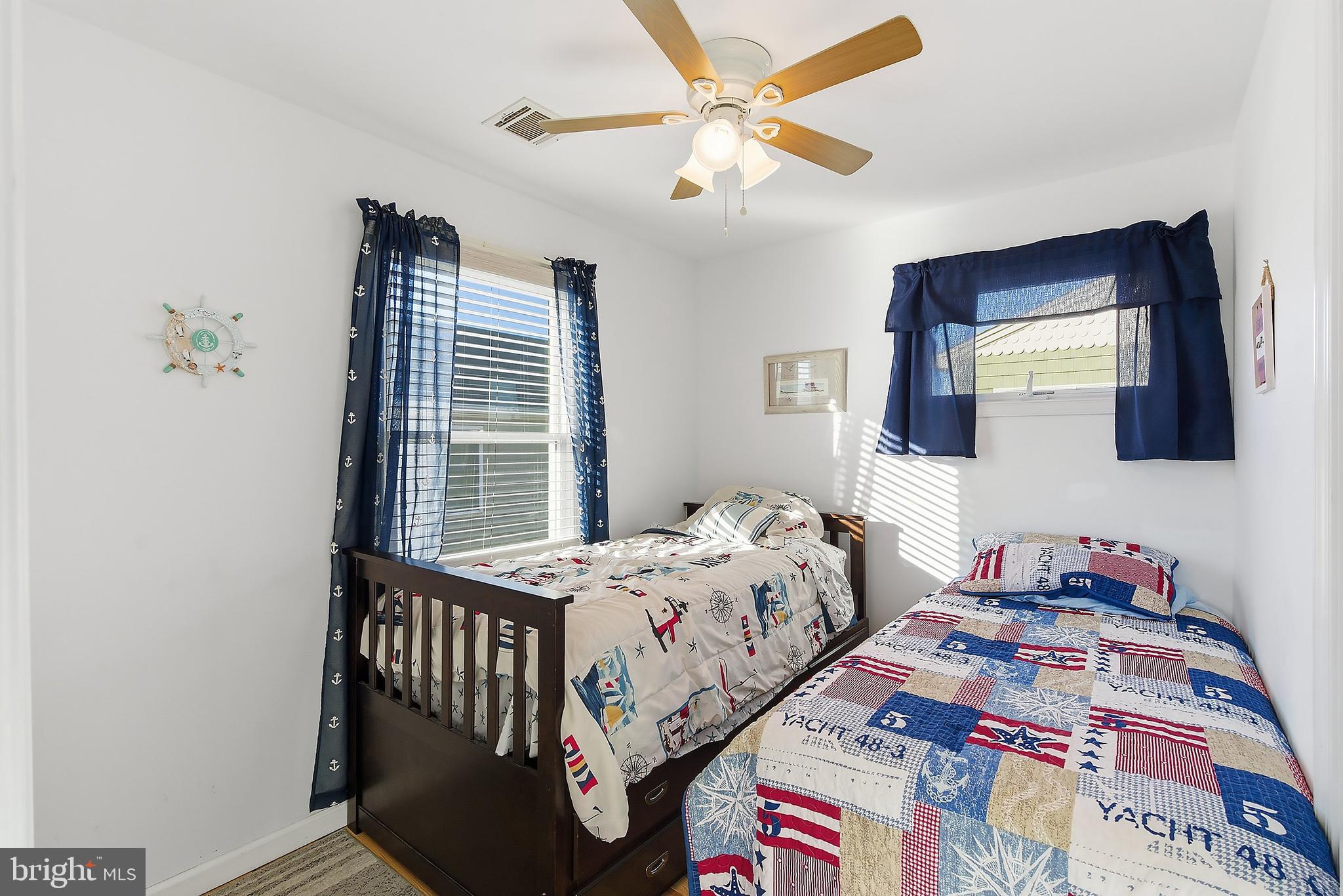 102 West Pompano Way Lavallette, NJ 08735 - Photo 14 of 28 a bedroom with a bed and a chandelier
