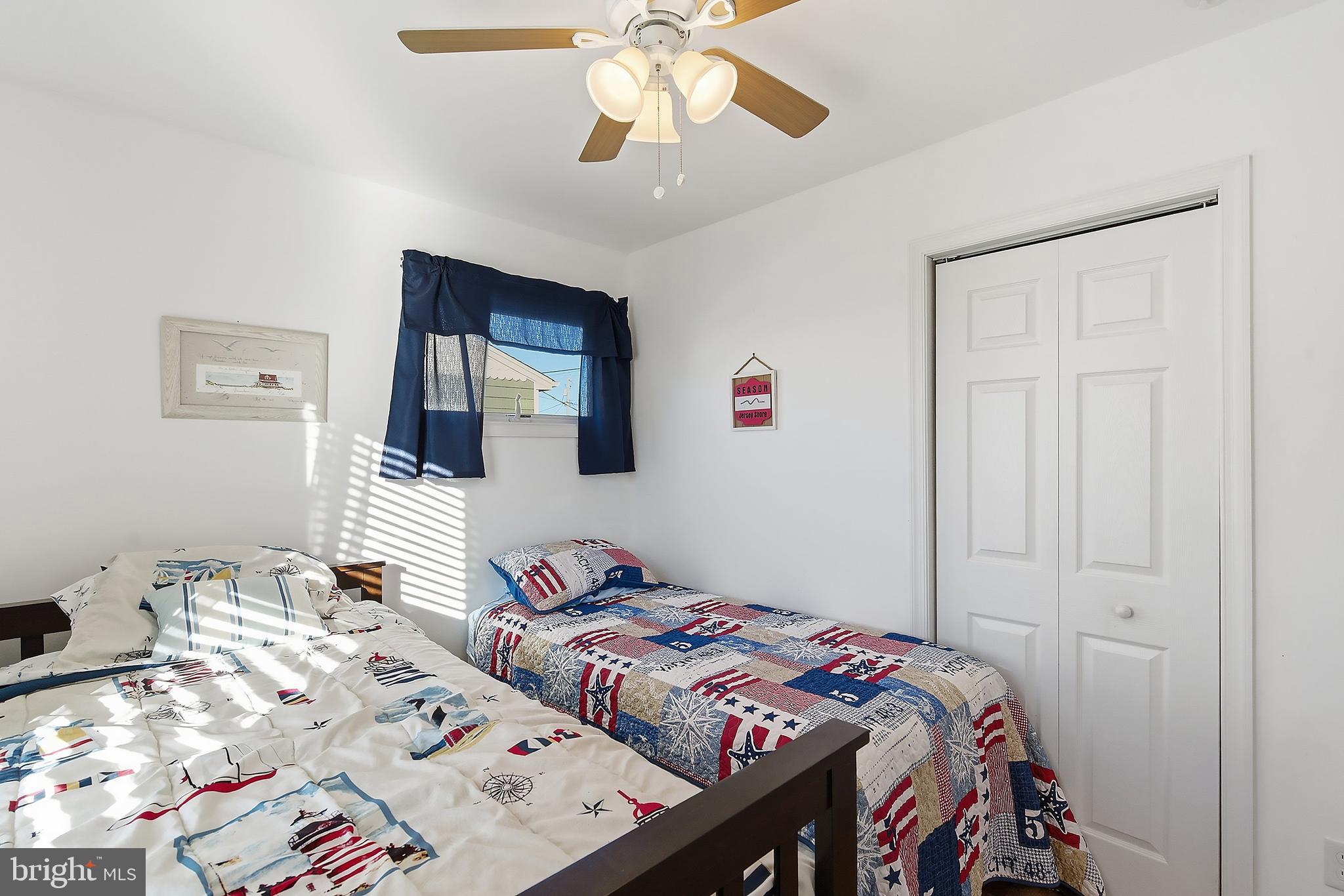 102 West Pompano Way Lavallette, NJ 08735 - Photo 15 of 28 a bedroom with a bed and a chandelier