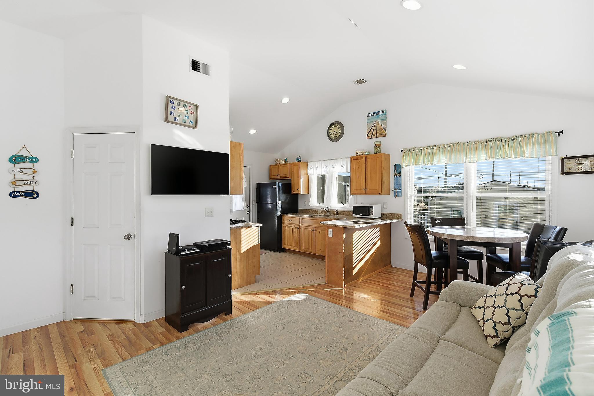 102 West Pompano Way Lavallette, NJ 08735 - Photo 3 of 28 a living room with fireplace furniture and a flat screen tv