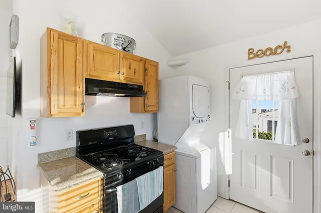 a kitchen with stainless steel appliances granite countertop a stove and a sink