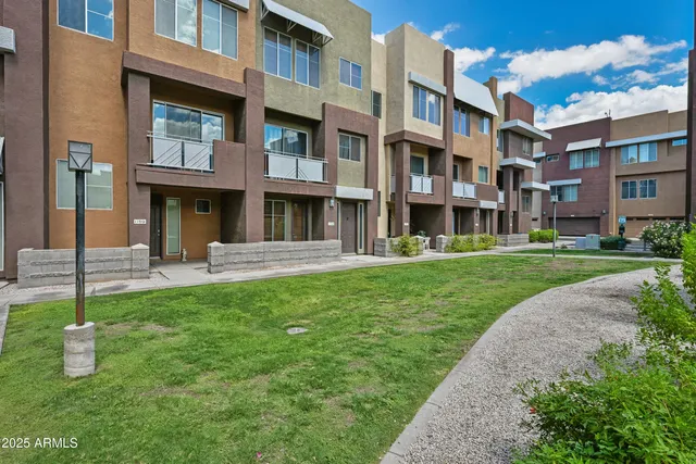 a front view of a building with a yard