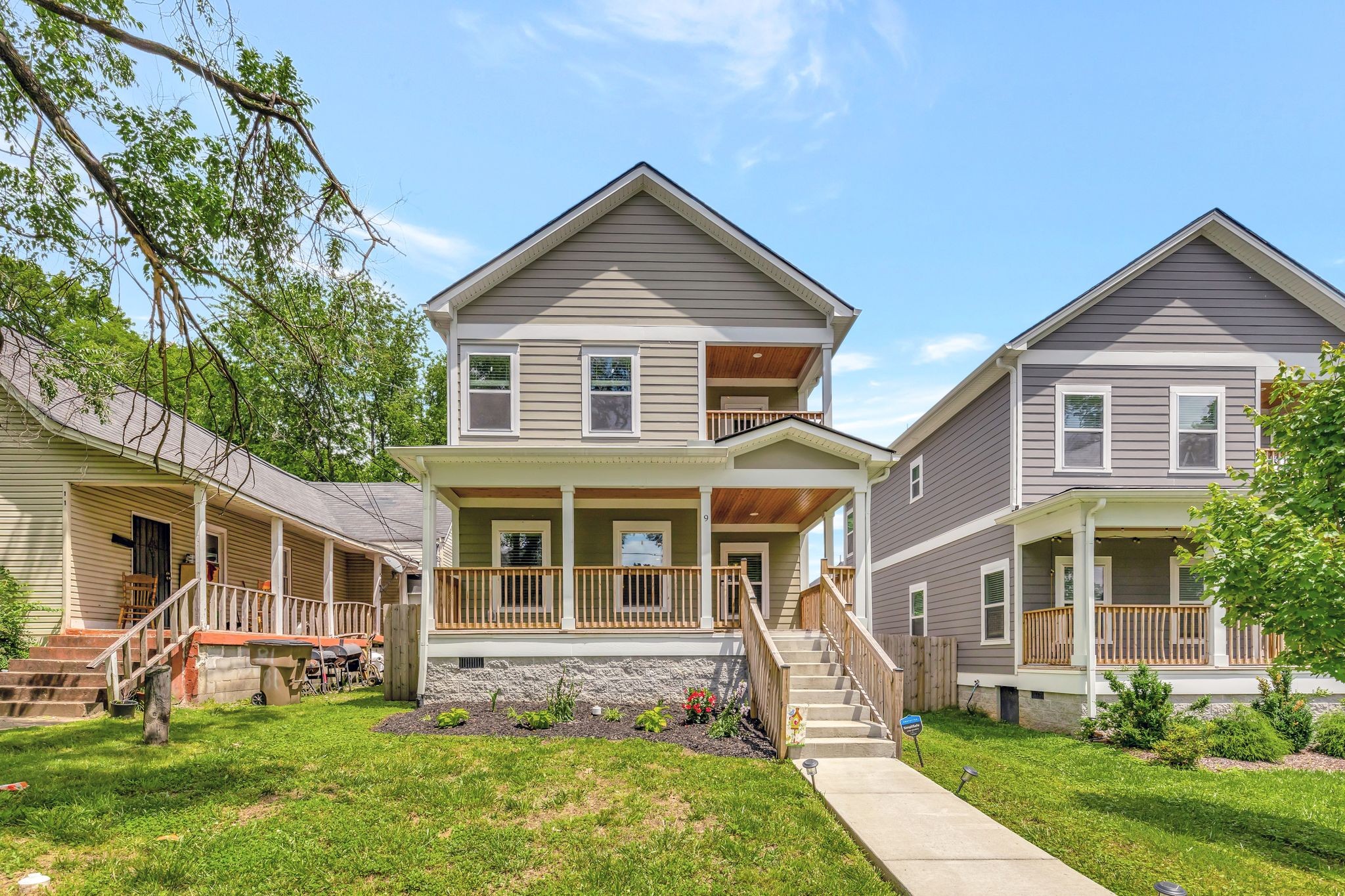 a front view of a house with a yard and plants