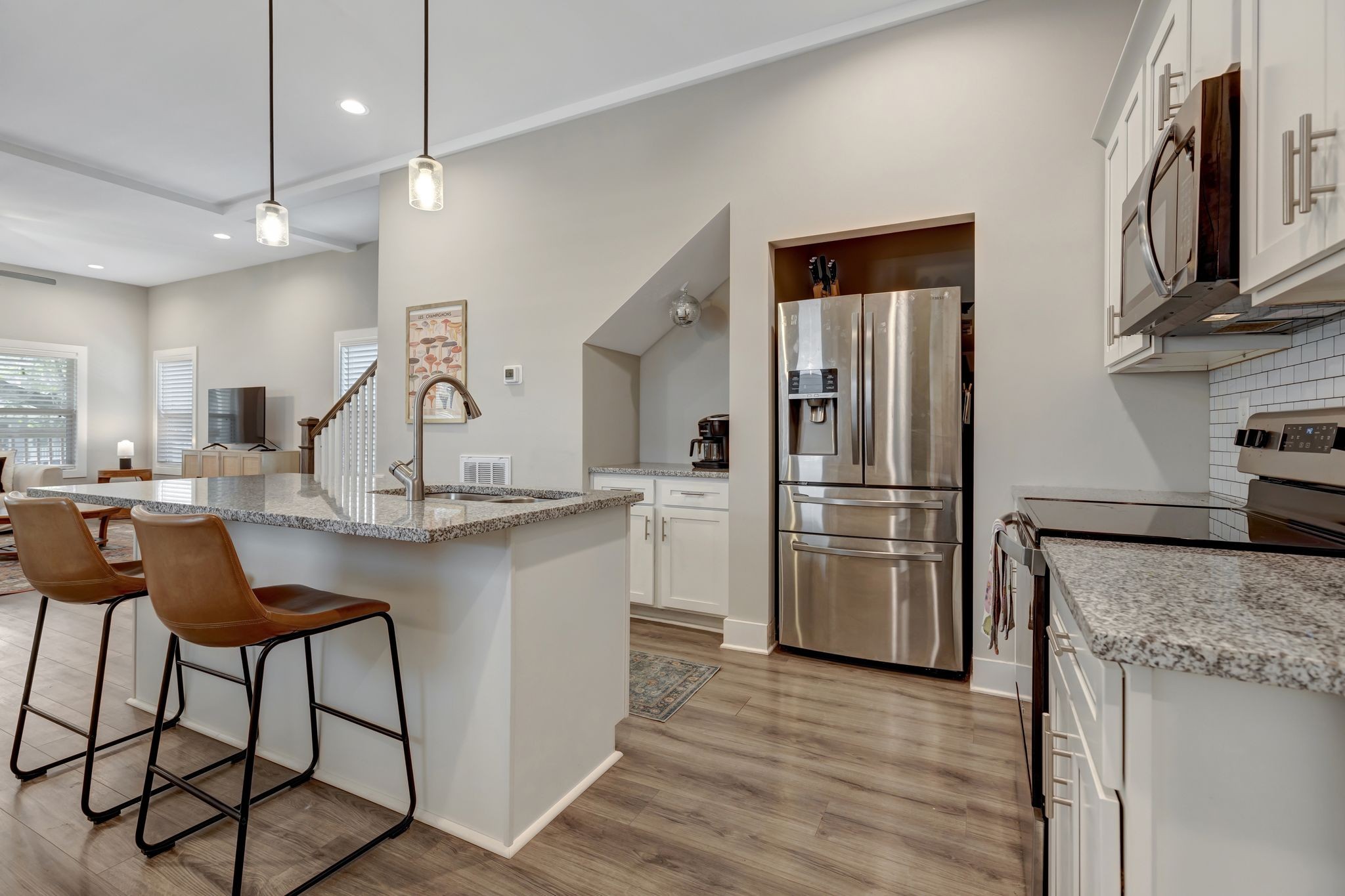 9 Decatur Street Nashville, TN 37210 - Photo 11 of 31 a kitchen with stainless steel appliances granite countertop a refrigerator a stove and a sink with wooden floor