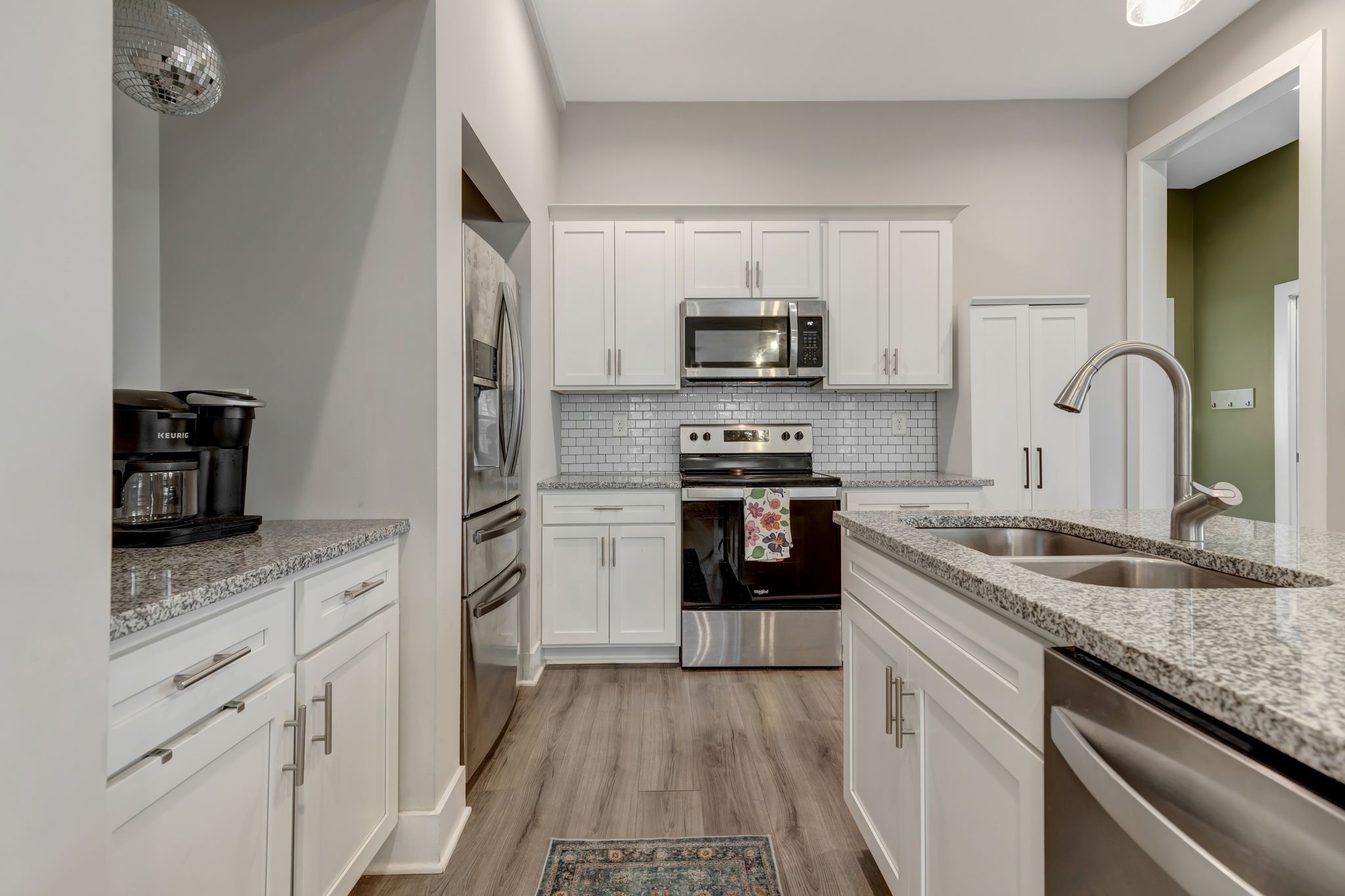 9 Decatur Street Nashville, TN 37210 - Photo 12 of 31 a kitchen with appliances a sink and cabinets