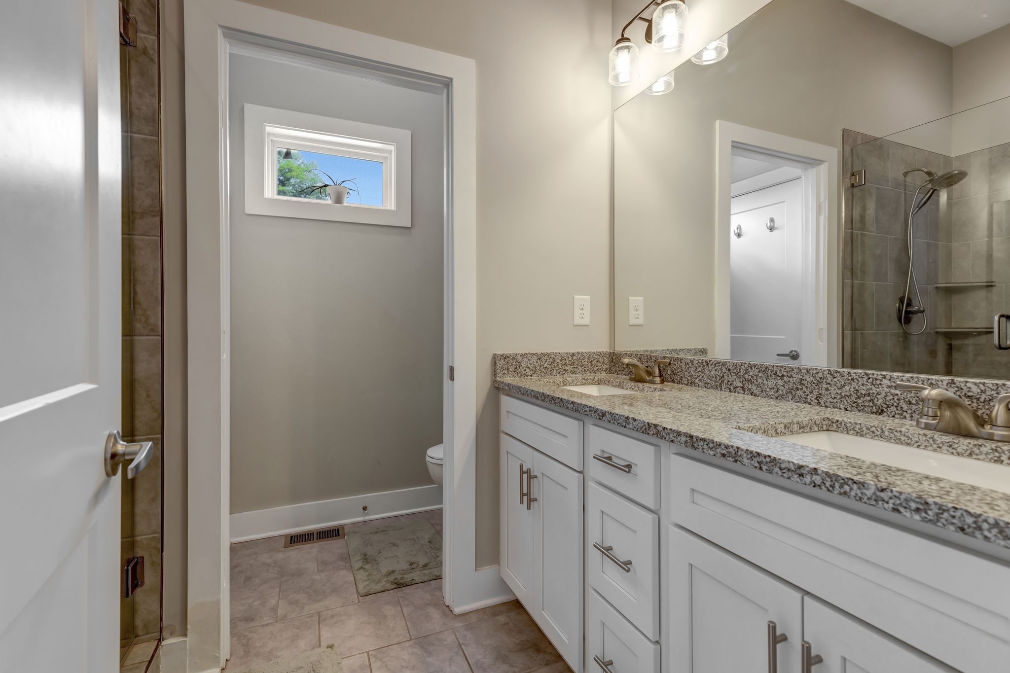 9 Decatur Street Nashville, TN 37210 - Photo 17 of 31 a bathroom with a granite countertop sink and a mirror
