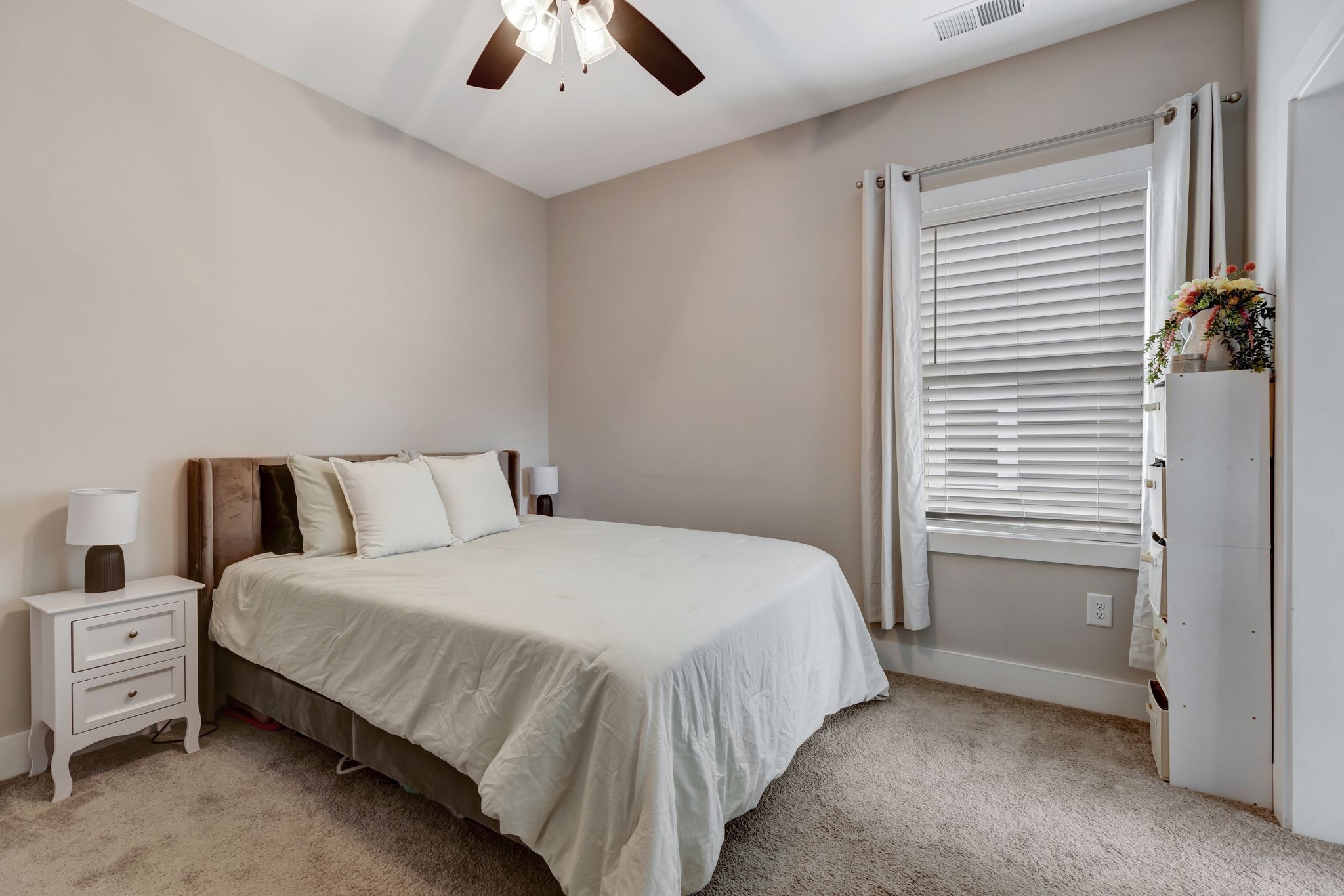 9 Decatur Street Nashville, TN 37210 - Photo 25 of 31 a bedroom with a bed and a chandelier