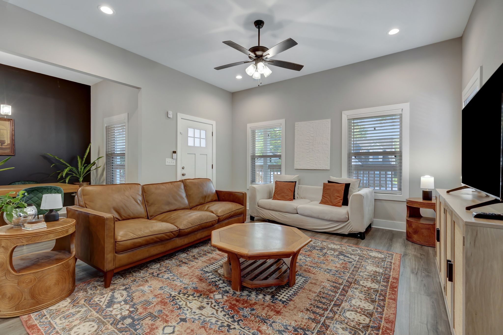 9 Decatur Street Nashville, TN 37210 - Photo 8 of 31 a living room with furniture a table and a flat screen tv