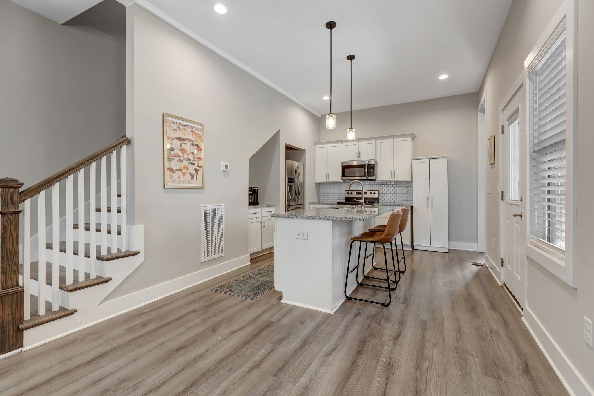 9 Decatur Street Nashville, TN 37210 - Photo 10 of 31 a kitchen with a refrigerator a stove a microwave and white walls