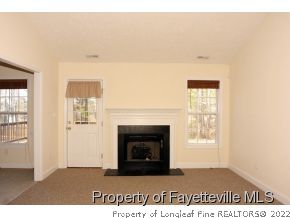 230 Lakeside Road Raeford, NC 28376 - Photo 3 of 20 a living room with a fireplace and a window