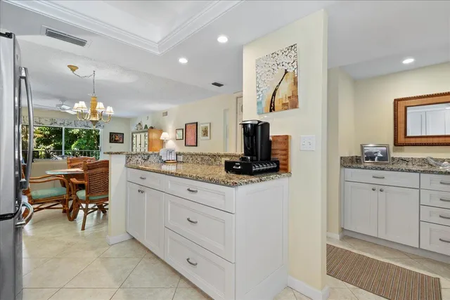 a spacious bathroom with a granite countertop sink mirror and bathtub