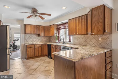 a kitchen with stainless steel appliances a refrigerator and a stove top oven