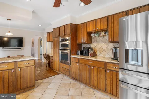 a living room with furniture ceiling fan and a rug