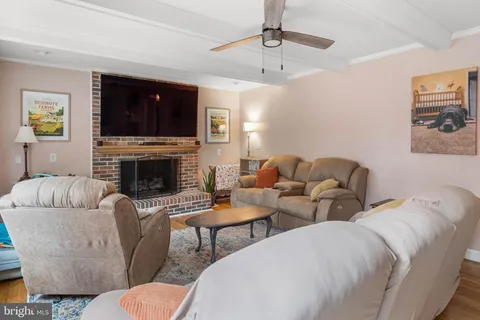 a living room with furniture and floor to ceiling windows