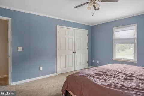 a bedroom with bed and window
