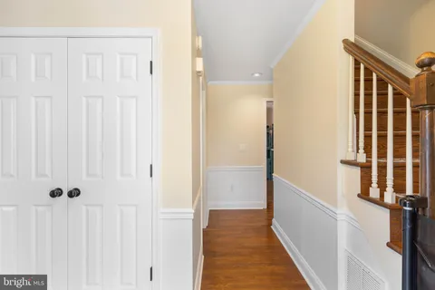 a kitchen with stainless steel appliances granite countertop a stove top oven a sink a dining table and chairs