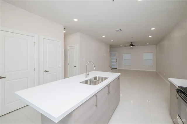 a kitchen with a sink and a refrigerator