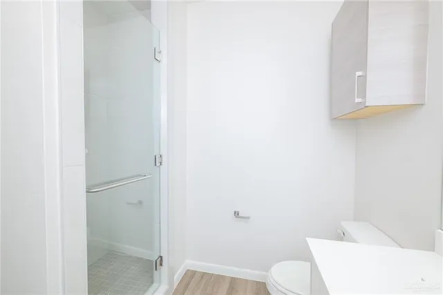 a bathroom with a toilet and a shower