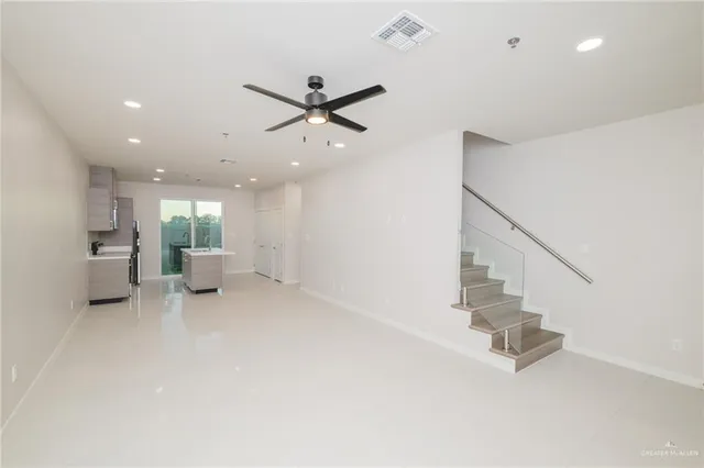 a view of a livingroom with furniture and a ceiling fan