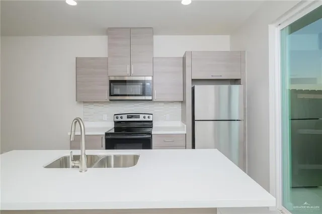 a kitchen with a refrigerator sink and microwave