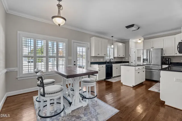 a kitchen with granite countertop a sink stove and cabinets