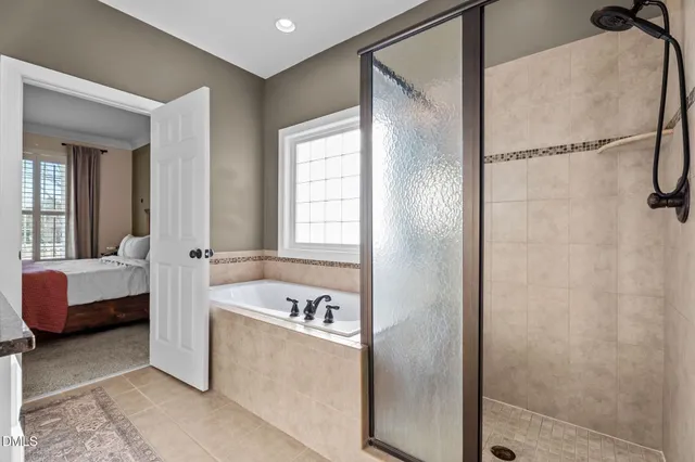 a bathroom with a tub shower and sink