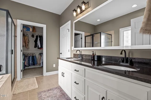 a bathroom with a tub shower and sink