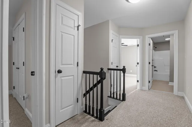 a view of a hallway with a door to a hallway