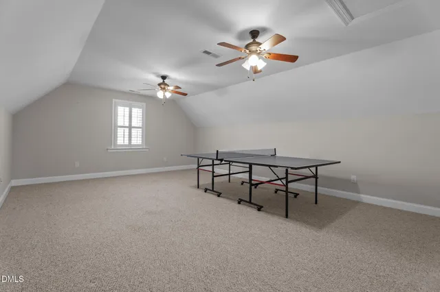 a view of a livingroom with furniture and chandelier fan