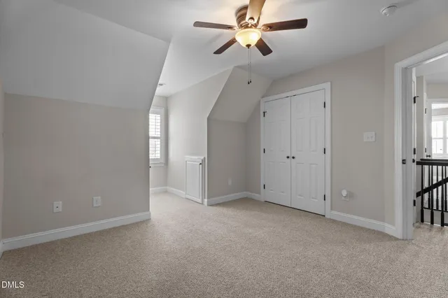 a view of a livingroom with furniture and chandelier fan