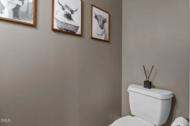 a white toilet sitting next to a bathroom sink