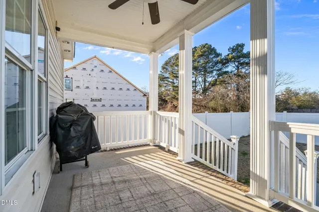 a view of a porch with wooden floor and iron stairs